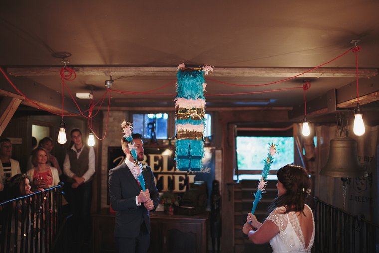 Bride and Groom smashing pinata